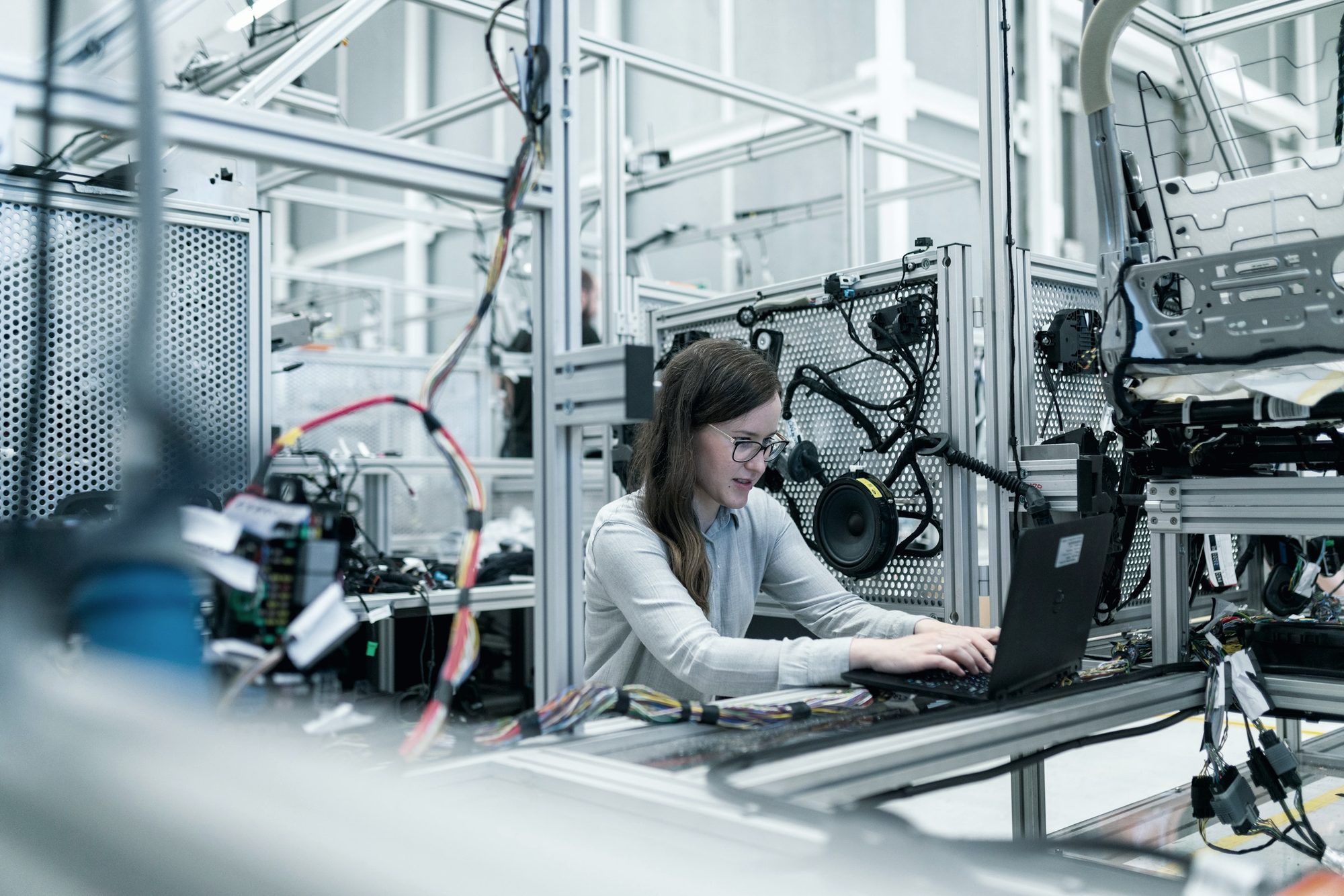 An engineer working at a laptop inside an automated vehicle test rig